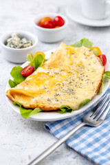 Fried eggs with cheese, cherry tomatoes and fresh lettuce.