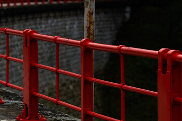 Red railings and stony dam of the Bystricka reservoir after a rainy afternoon.