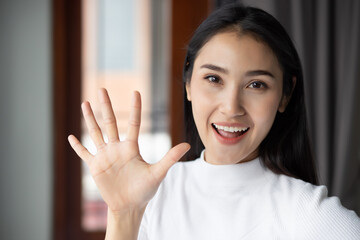 asian woman pointing, counting five fingers, portrait of happy smiling asian woman pointing up 5...