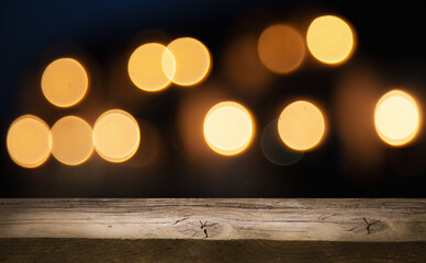 empty table on dark background with blurred lamps, cafe restaurant bokeh for your product or customization