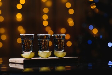 Obraz na płótnie Canvas tequila with lime on a dark background