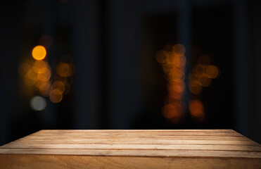 empty table on dark background with blurred lamps, cafe restaurant bokeh for your product or customization