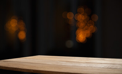 empty table on dark background with blurred lamps, cafe restaurant bokeh for your product or customization