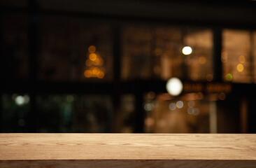 empty table on dark background with blurred lamps, cafe restaurant bokeh for your product or customization