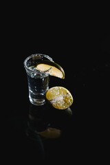 Fototapeta na wymiar tequila with lime on a dark background