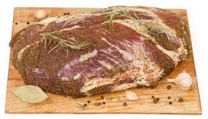 Pickled pork neck prepared for further curing on cutting board