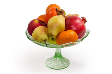 Different fruits in vintage glass fruit vase on white background