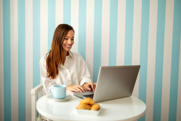 Fototapeta premium Young business woman having a relaxing morning at home. Work, technology, people, lockdown concept.
