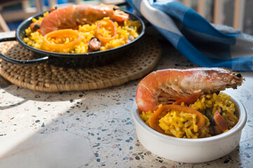 Paella typical spanish food in granite background