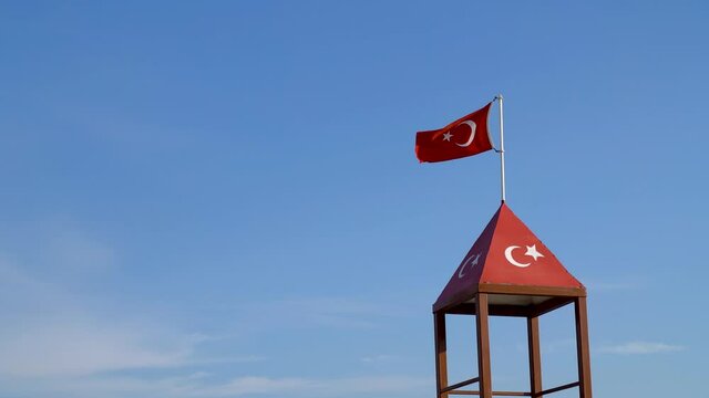 Turkish flag waving at blue sky. Turkey country flag flowing in the wind at blue sky.