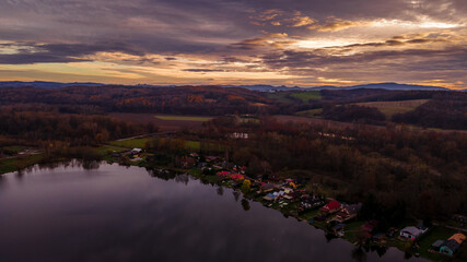 Aerial view of several divided ponds in a row during sunset in the area of Hustopece nad Becvou.