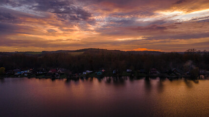 Aerial view of several divided ponds in a row during sunset in the area of Hustopece nad Becvou.