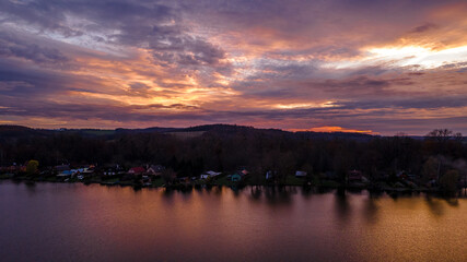 Aerial view of several divided ponds in a row during sunset in the area of Hustopece nad Becvou.