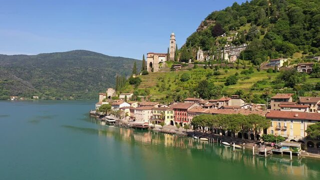 Aerial drone footage of the ancient Morcote village by lake Lugano in Canton Ticino in Switzerland on a sunny summer day. 