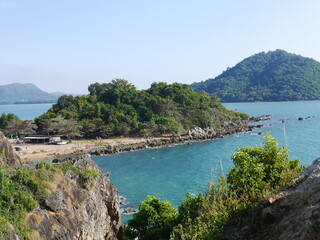Beautiful views of the road curving along the mountains and the sea.