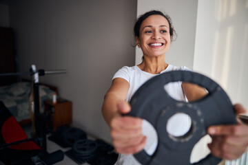 Joyous fit woman performing a strength exercise