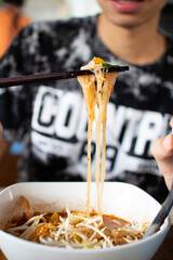 person eating noodles