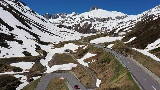 aerial, aerial footage, alpine, alps, altitude, beautiful, blue, building, cold, curve, drone, environment, famous, freedom, furka, furkapass, green, hairpin, hairpin bend, hotel, landmark, landscape,