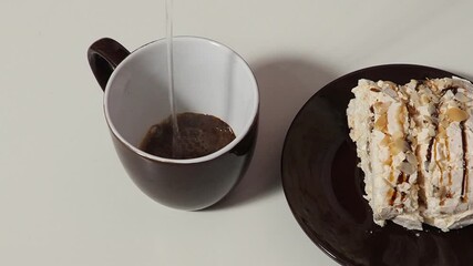 Slice piece of vanilla cake topping with white chocolate chips for coffee or tea break, on white with almond petals, coconut flakes, takes it out of the box, puts it on a saucer, eats, pours coffee