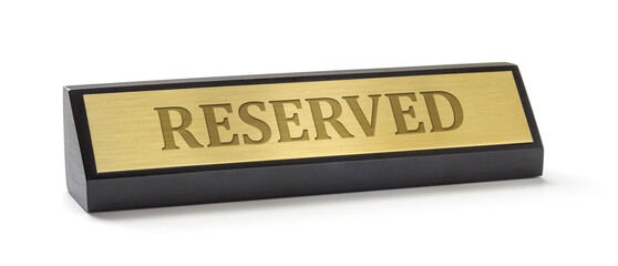A name plate on a white background with the engraving Reserved