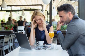 Worried business woman on a meeting in the restaurant, bad news concept
