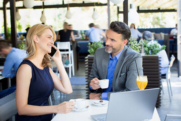 Handsome couple having business meeting in the cafe restaurant