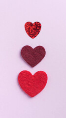 Flatlay red hearts on a pink background. Concept of Valentine's day, wedding. Copy space.