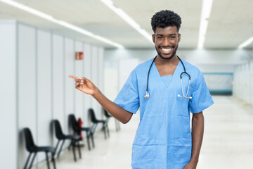 Handsome african american male nurse at vaccination station is ready for vacinating patients...