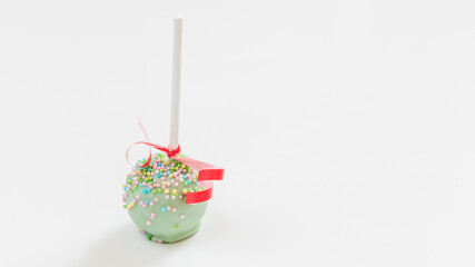 Colorful cake pops on white background