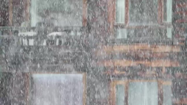 It's snowing at the window,  heavy snowfall in a small mountain town