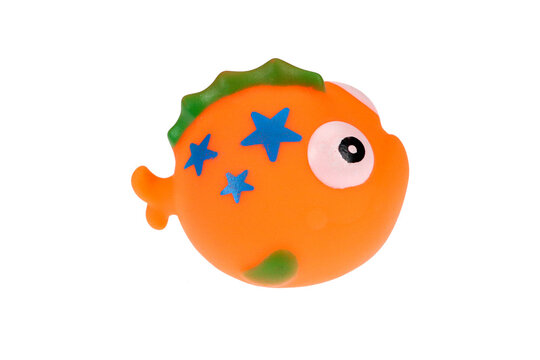 Orange rubber toy fish. On a white background, isolated.