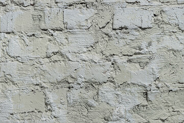 Wall of white inhomogeneous yellow brick. Light shabby texture