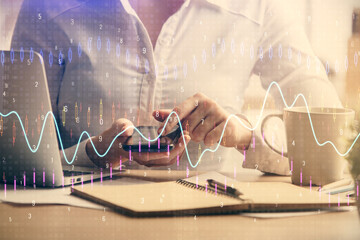 Double exposure of forex chart sketch hologram and woman holding and using a mobile device. Financial market concept.