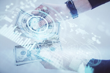 Multi exposure of financial theme drawing hologram and USA dollars bills and man hands. Business concept.