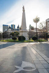 Plaza de Mayo square in Buenos Aires, Argentina. It is believed to be the foundational site of the city. The May pyramid is lit by sunrays, mothers of plaza de mayo's symbol on the ground