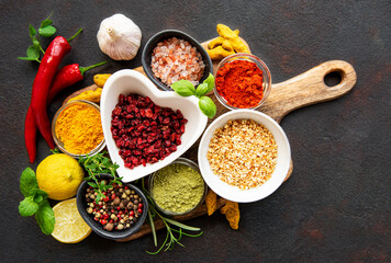 Dry seasonings and spices against a dark background view from the top.
