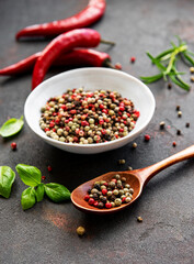 Red hot chili pepper corns and pods on dark  background, top view