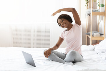 Happy black woman making morning exercise at home