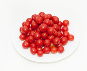 Cherry tomatoes in a plate on a white background