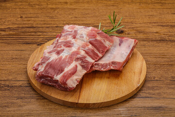 Raw pork ribs served rosemary