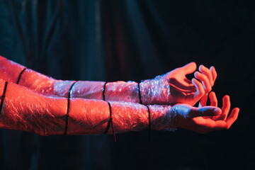 Drug addiction. Rehab therapy. Treatment support. Male junkie arms wrapped in polyethylene film...