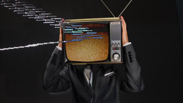 Man wearing suit with TV on head