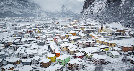 scenic view of village against snow covered mountains. Village of Mezzocorona, Trento province, Trentino Alto Adige, northern Italy. winter lanscape