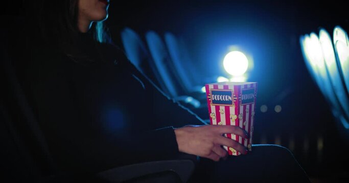 Giovane ragazza mangia pop corn al cinema