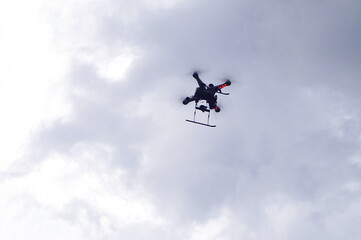 Naklejka na ściany i meble Drone flying in the clouds