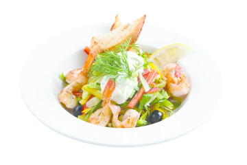 Seafood Caesar salad with shrimp, arugula, and parmesan cheese on a round white plate. Isolated.
