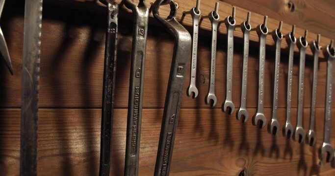 Wrench tool set hanging on wooden wall in professional workshop garage