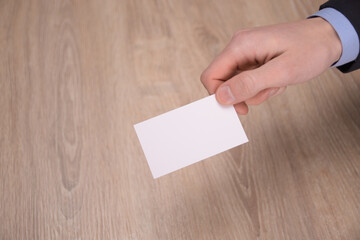 Hand hold blank white card mockup with rounded corners. Plain call-card mock up template holding...