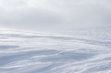 Textured surface of a snow-covered slope. Selective focus.