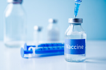 A single bottle vial of Covid-19 vaccine. Medical concept vaccination hypodermic injection...